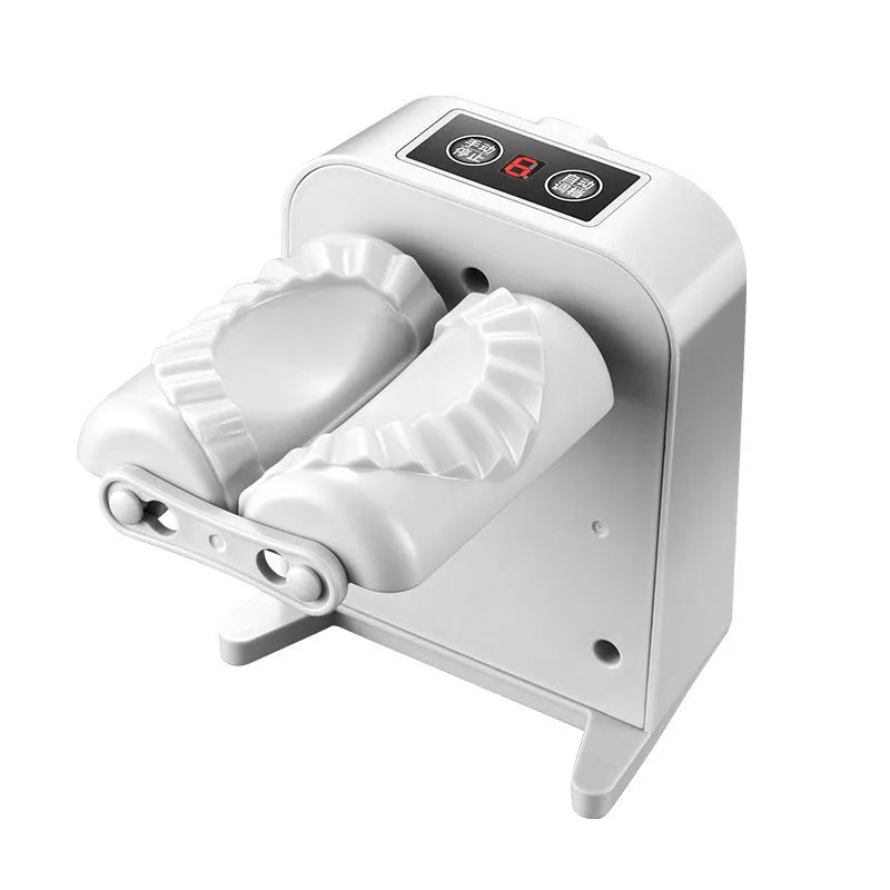 White electric dumpling maker machine with USB charging cable, brush, and spoon.