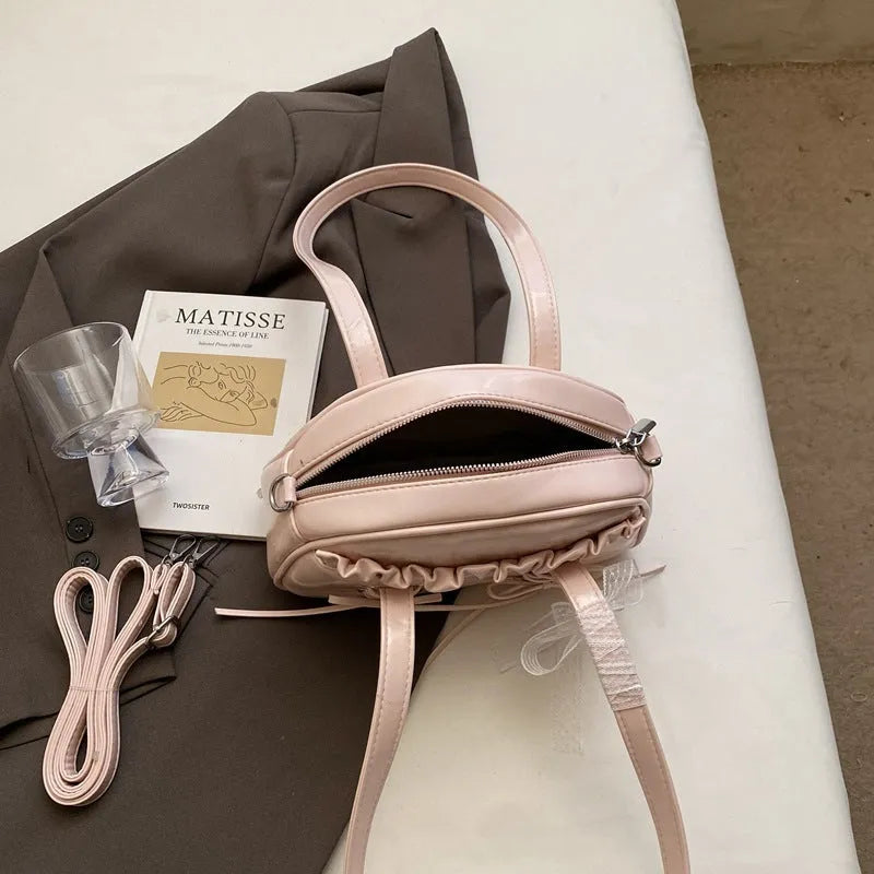 Women's bandage bow handbag in PU leather with mobile phone compartment and decorative sewing thread details