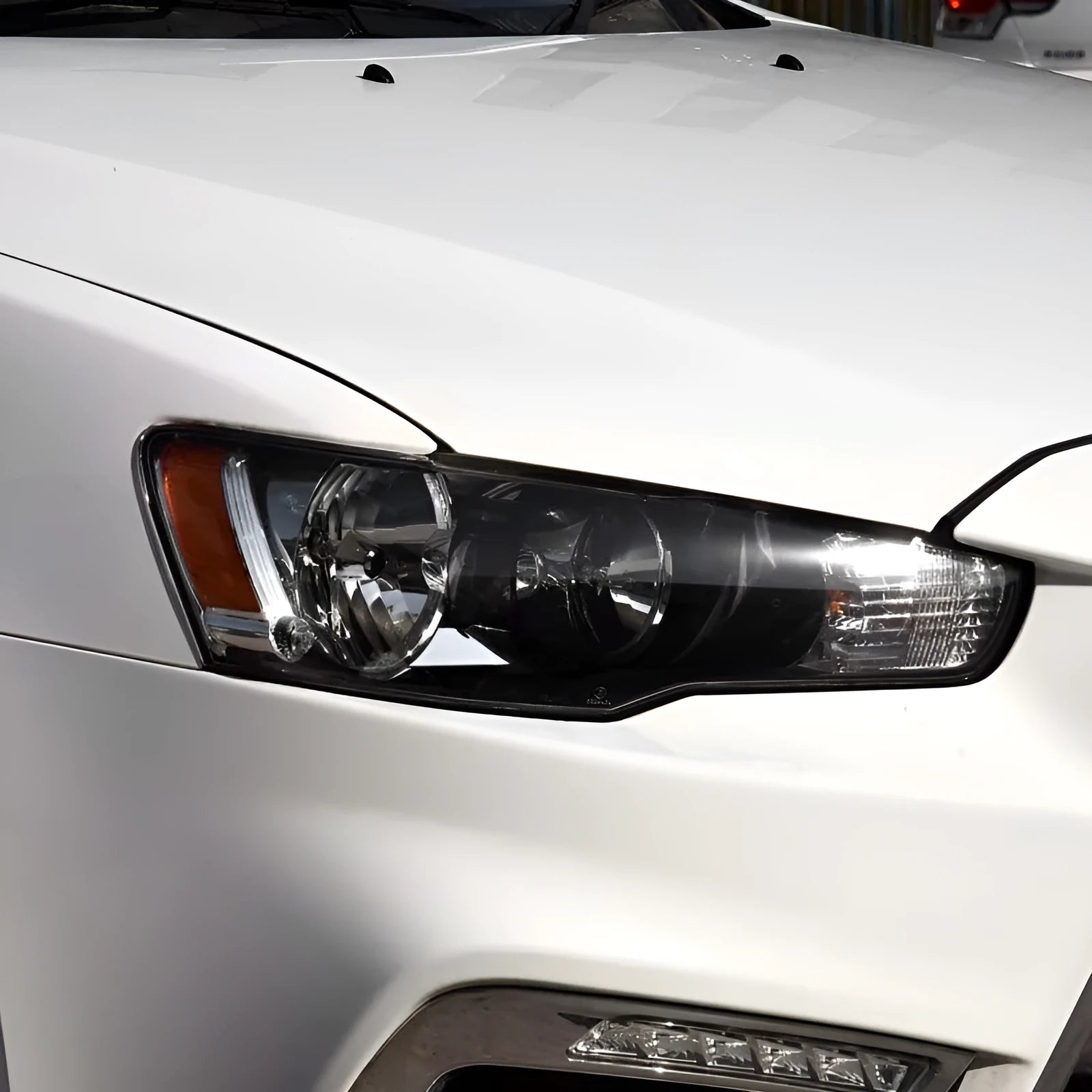 Transparent plastic automotive headlight housing cover showing clear construction