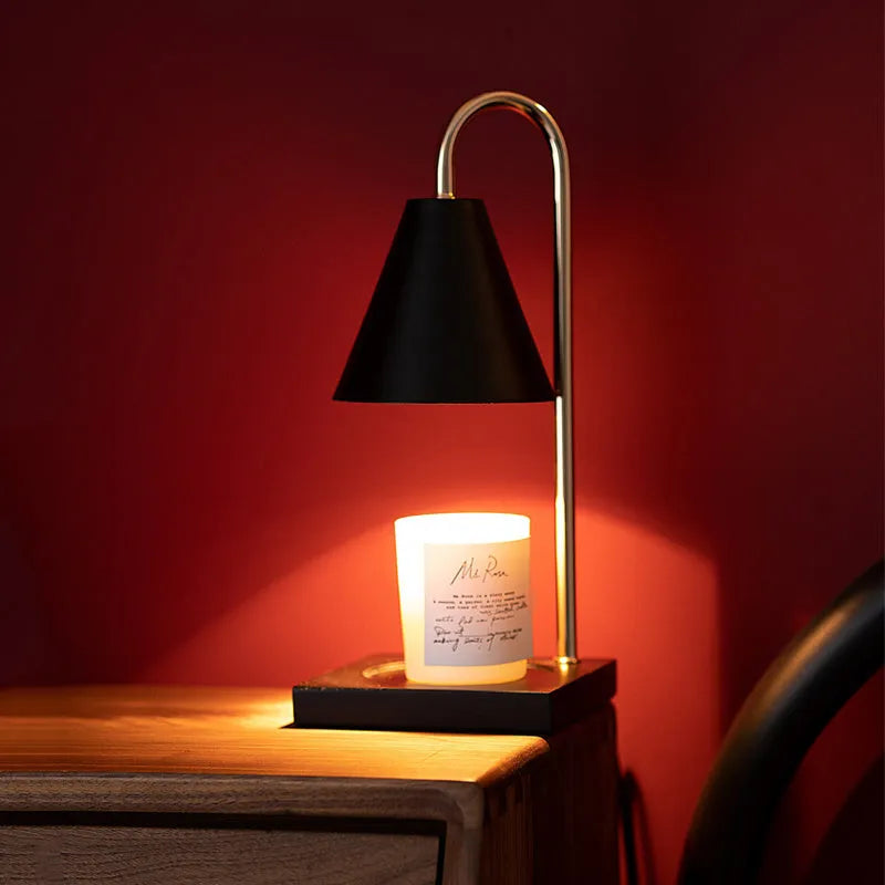 White and log coloured electric candle warmer lamp with dimmer switch on desk