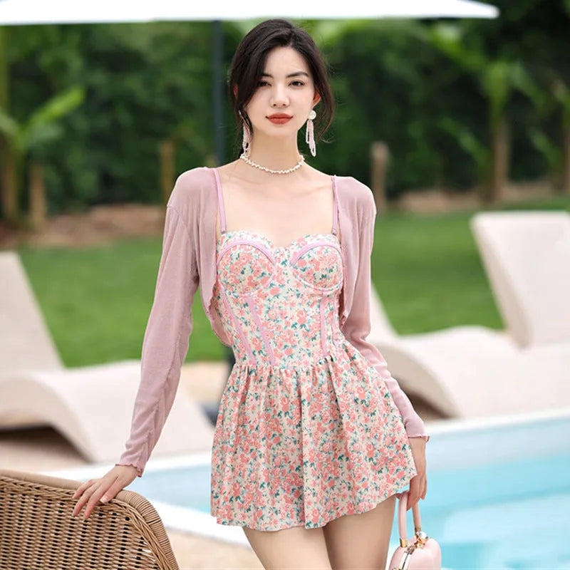 Women's floral one-piece swimsuit with suspender straps in green and pink colour options