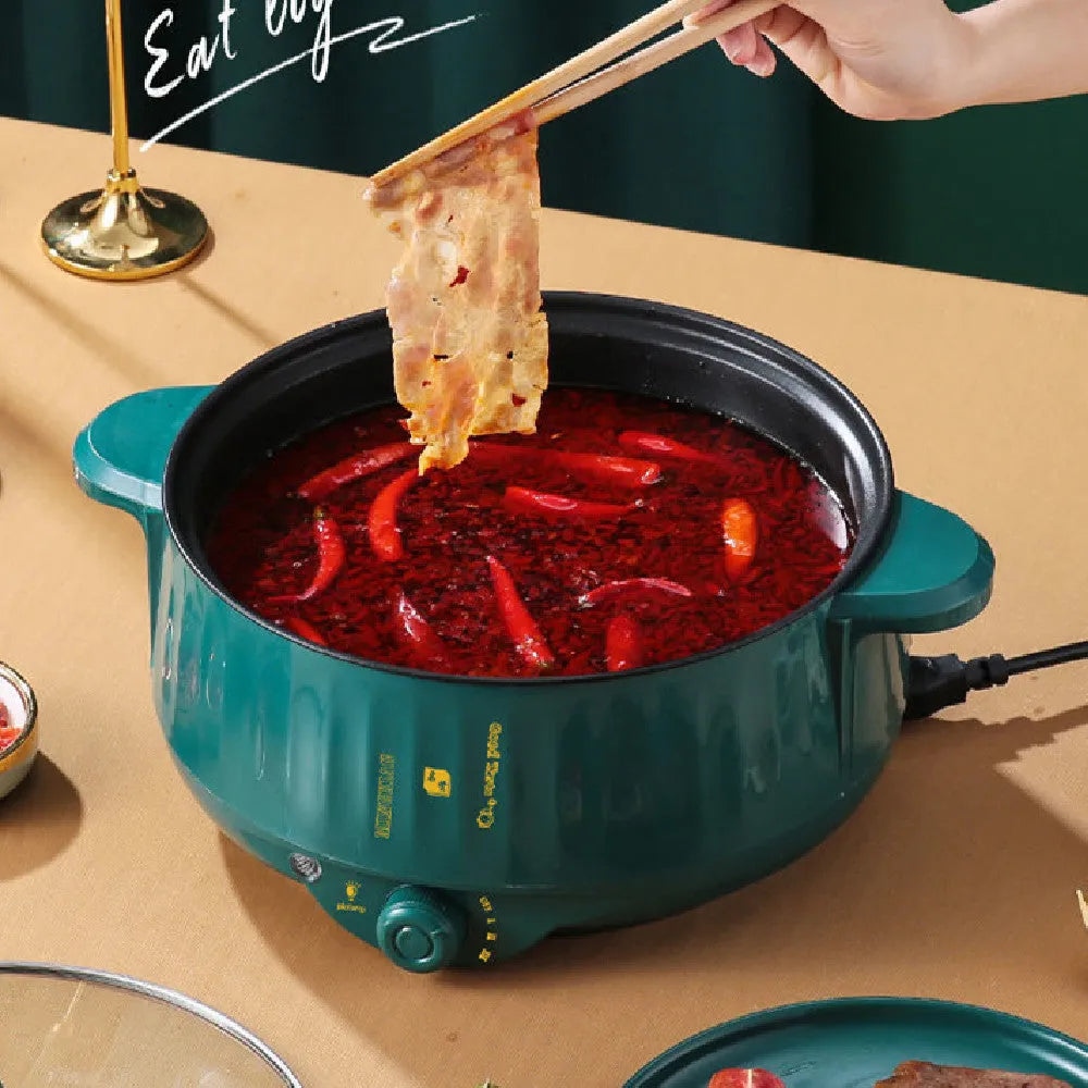 Stainless steel electric pot with non-stick interior showing steaming, frying, boiling, and stewing functions