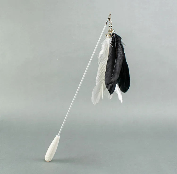 Telescopic cat fishing rod extended, showing goose feather bell toy and removable pen on fibre shaft