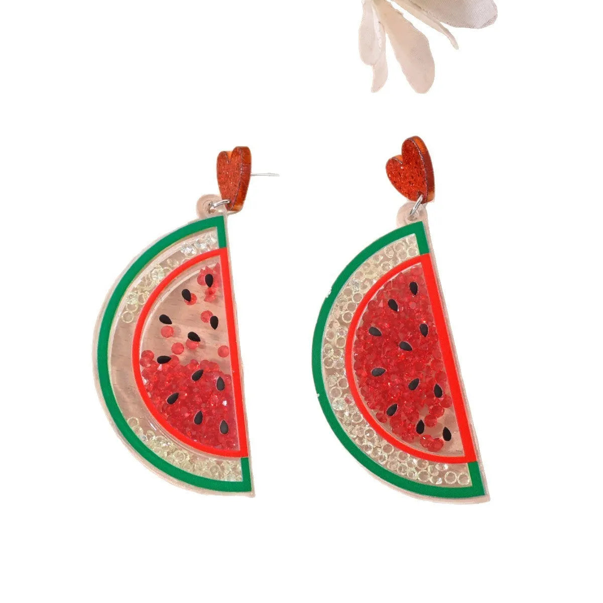 Seven pairs of colourful acrylic fruit and dessert stud earrings on a white background.