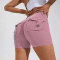 Women's high waist hip lifting shorts in avocado green with side pockets during yoga pose
