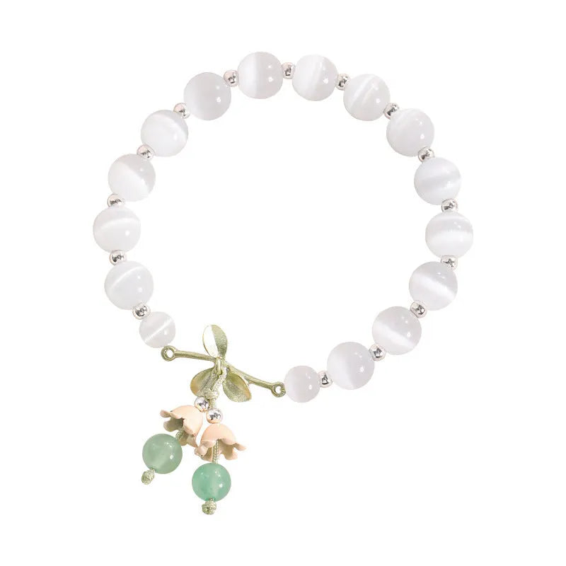 Women's bracelet with multiple diamond-shaped cat's eye opal beads on a string.