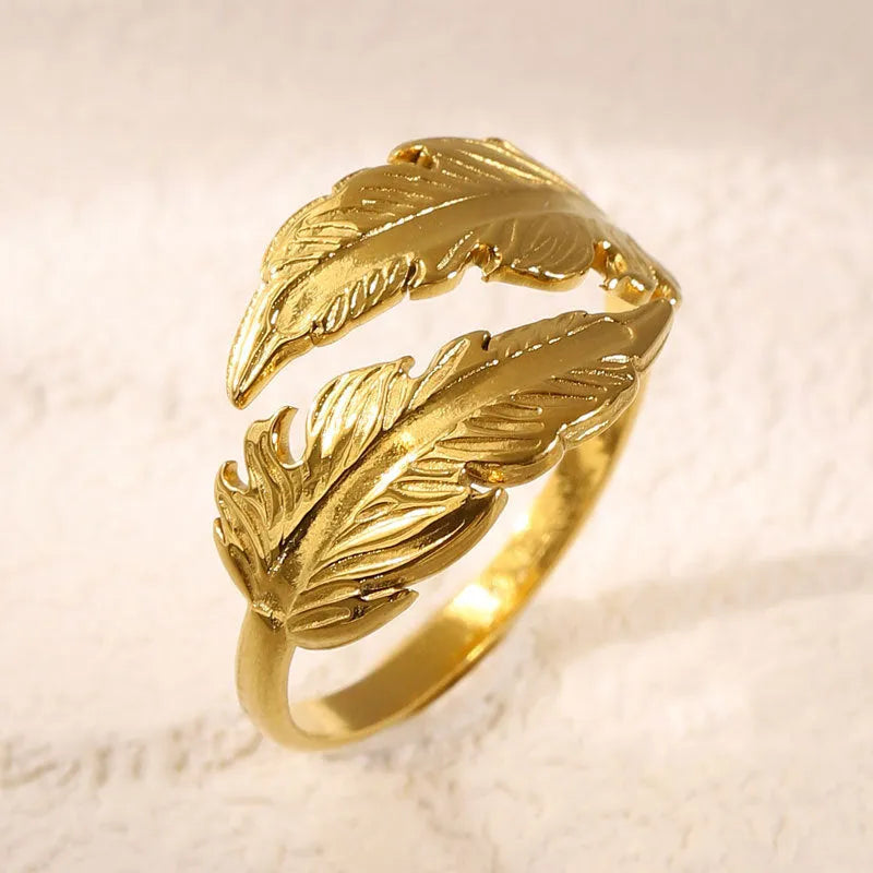 Women's adjustable opening feather fashion ring in silver or gold colour on titanium steel.