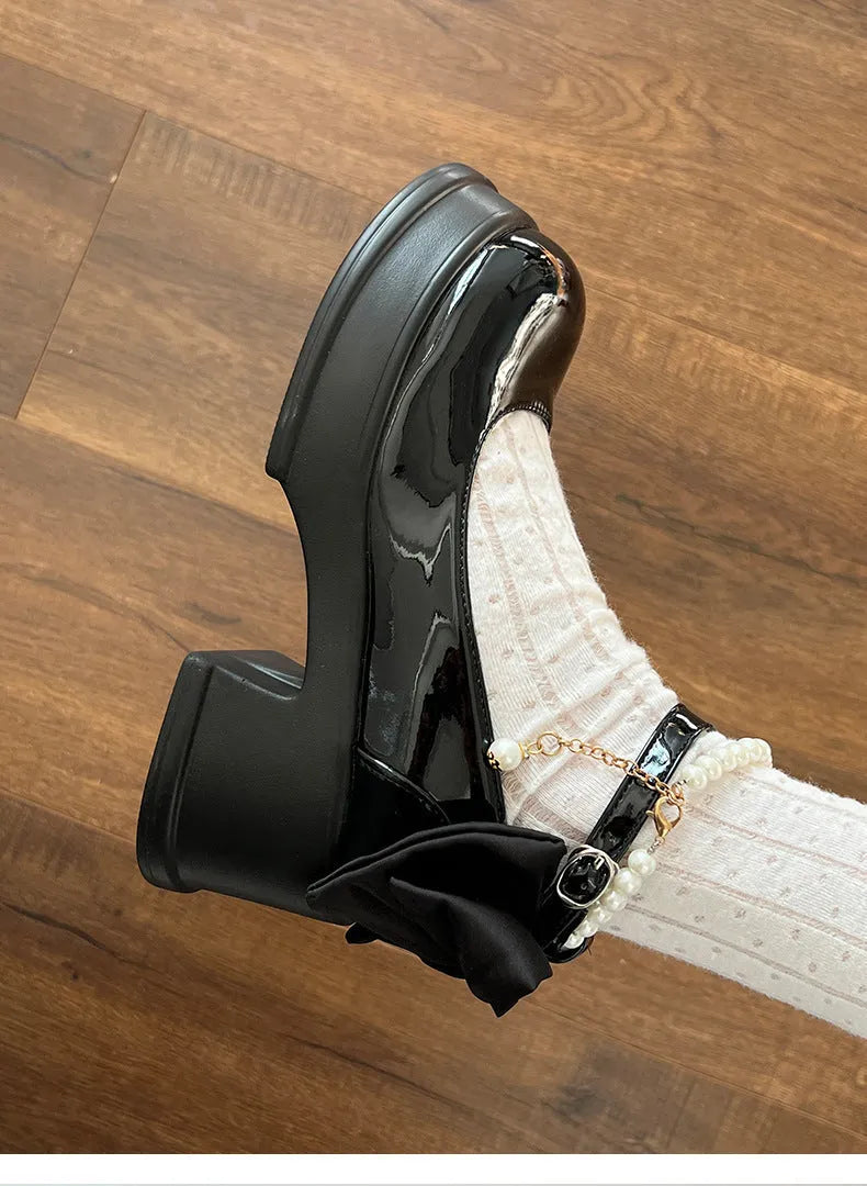 Black and beige women's chunky heel Mary Jane shoes with a round toe and shallow cut.